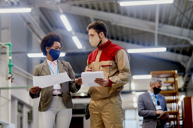 Affordable Hazardous Waste Training That Actually Sticks with Manufacturers African American businesswoman talking to a worker