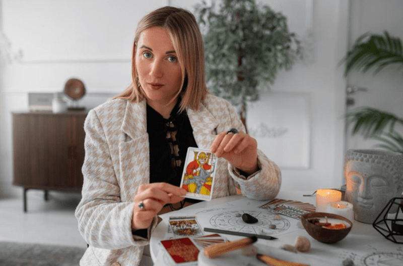 Which is the Most Powerful Card in Tarot? A woman is showing Tarot card