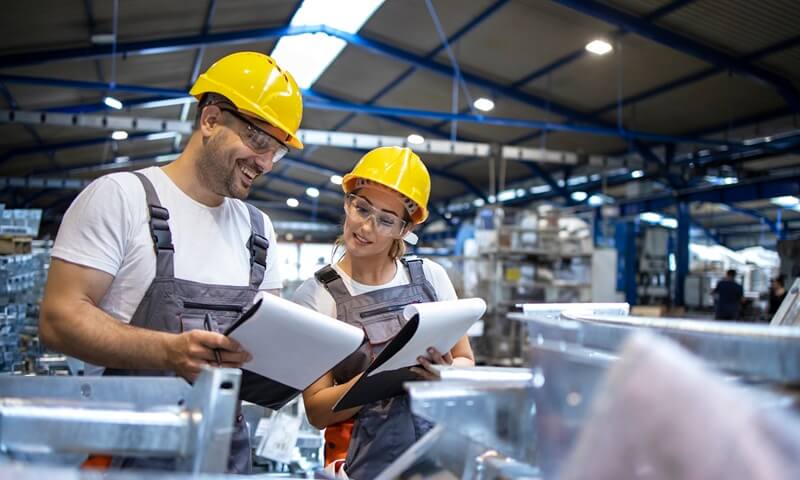 How OEMs Can Reduce Tooling Costs With Strategic Fabrication Choices Factory workers in a OEM factory